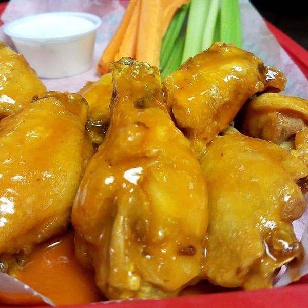San Diego's Mexican Grill's chicken wings with sauce, carrots, celery, and a side of ranch.